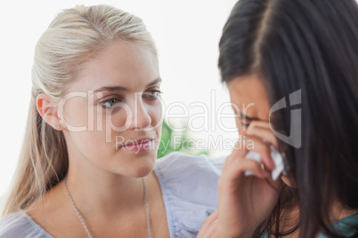 Blonde listening to her tearful friend