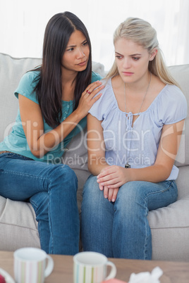 Friend comforting her upset friend