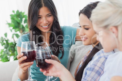 Cheerful friends having red wine together