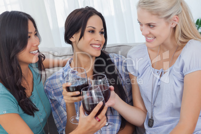 Cheerful friends enjoying red wine together