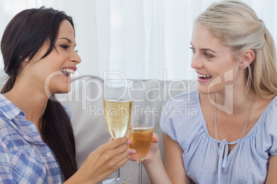 Happy friends toasting with champagne