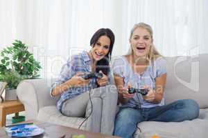Happy friends playing video games and having fun