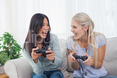 Silly friends playing video games and laughing
