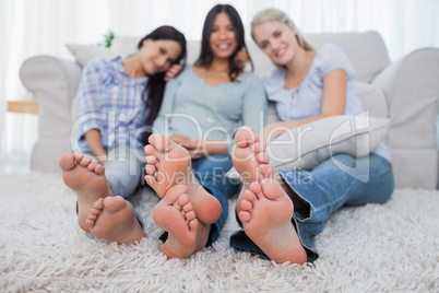 Friends relaxing on floor and smiling at the camera