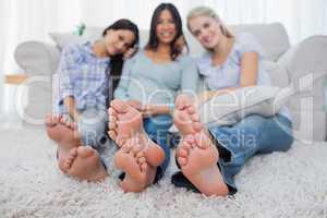 Friends relaxing on floor and smiling at the camera