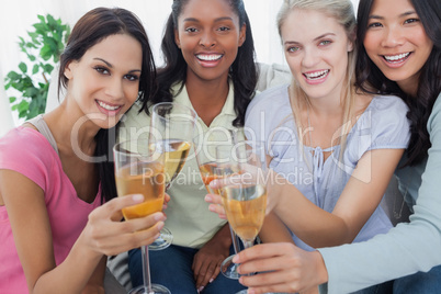 Friends toasting with white wine at the camera