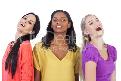 Diverse young women laughing at camera