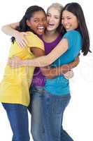 Diverse laughing women embracing each other