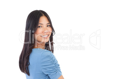 Smiling asian woman looking over her shoulder