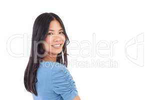 Smiling asian woman looking over her shoulder