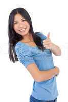 Happy asian woman giving thumb up at camera