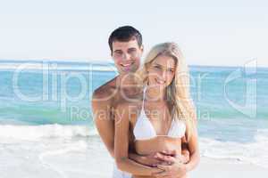 Gorgeous couple embracing and smiling at camera