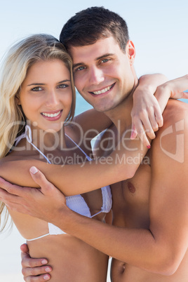Sexy couple hugging and smiling at camera