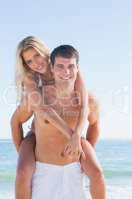 Man giving his pretty girlfriend a piggy back