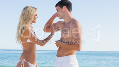 Man showing off muscles to pretty blonde