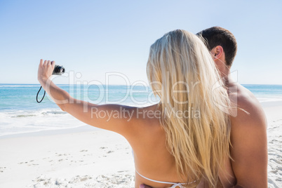 Blonde taking picture of herself with boyfriend