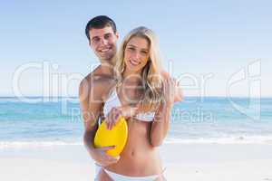 Man holding frisbee and hugging his girlfriend