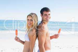 Happy young couple holding ice creams