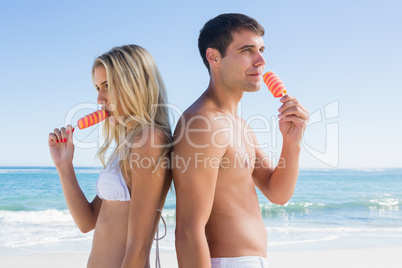 Happy young couple eating ice creams