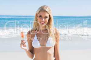 Beautiful blonde holding ice lolly