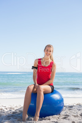 Fit blonde sitting on exercise ball