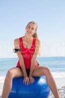 Fit young woman sitting on exercise ball