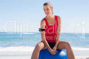 Fit woman sitting on exercise ball