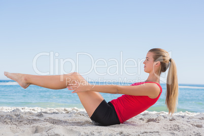 Fit blonde doing pilates core exercise