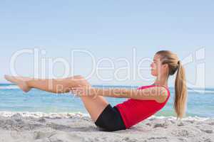 Fit blonde doing pilates core exercise