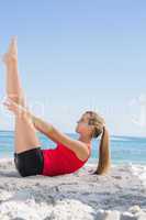Athletic blonde doing pilates core exercise
