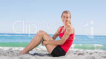 Athletic blonde sitting and smiling at camera