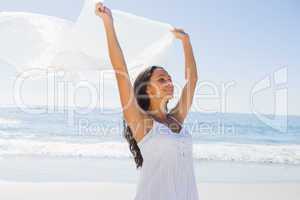 Beautiful brunette in white sun dress holding sarong