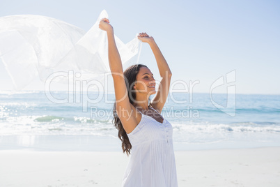 Pretty brunette in white sun dress holding sarong