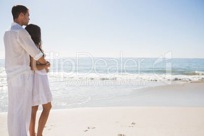 Attractive couple looking out at sea