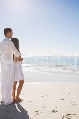 Attractive couple looking out at ocean