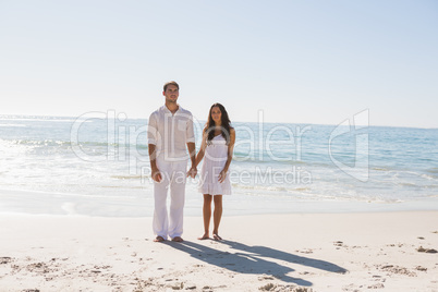 Beautiful couple holding hands and looking at camera