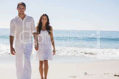 Beautiful couple holding hands and walking towards camera