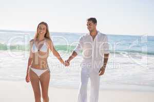 Beautiful blonde walking away from man holding her hand