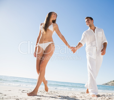 Beautiful blonde holding hands with happy boyfriend