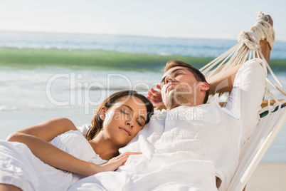 Peaceful couple napping in a hammock