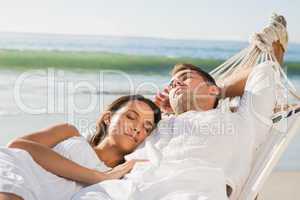 Peaceful couple napping in a hammock