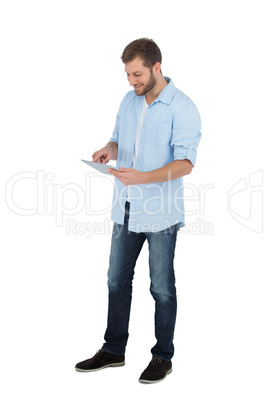 Relaxed male model using his tablet pc