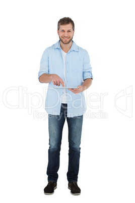 Relaxed male model posing with tablet computer