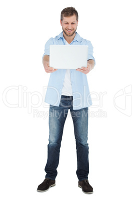 Relaxed model looking at his laptop