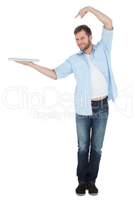Happy model holding laptop on right hand with flair