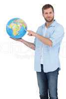 Casual man holding a globe