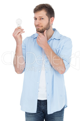 Handsome model holding a bulb