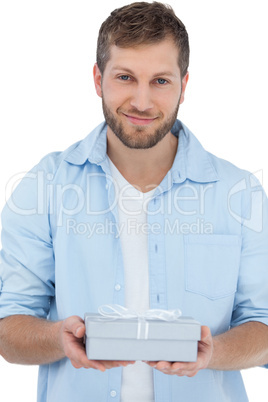 Handsome man holding a present looking at camera