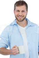 Smiling young model holding a mug