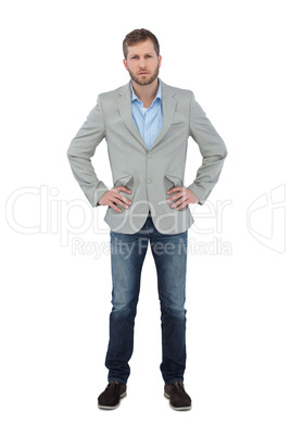 Serious trendy man posing with hands on hips